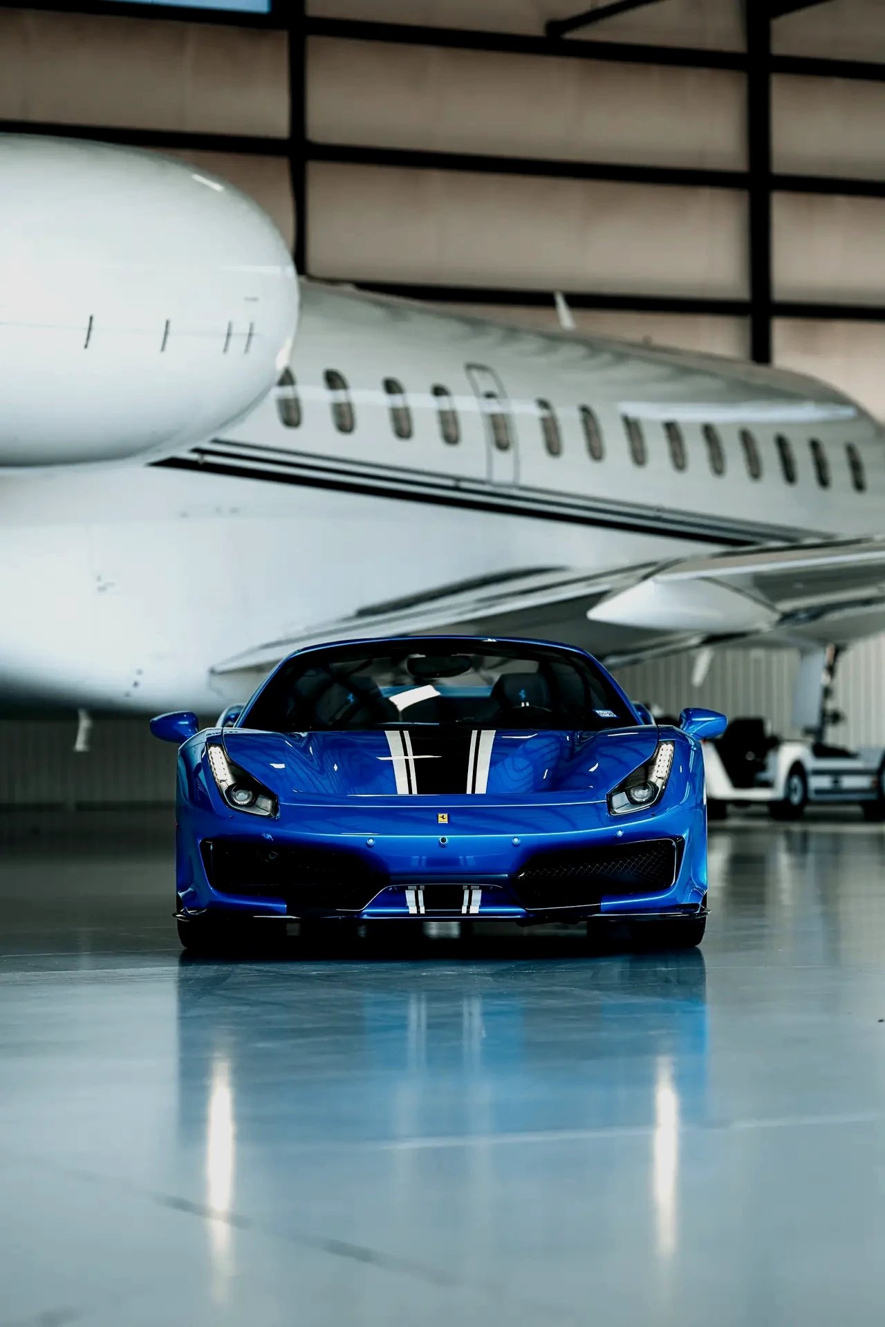 Blue Ferrari in aircraft hangar